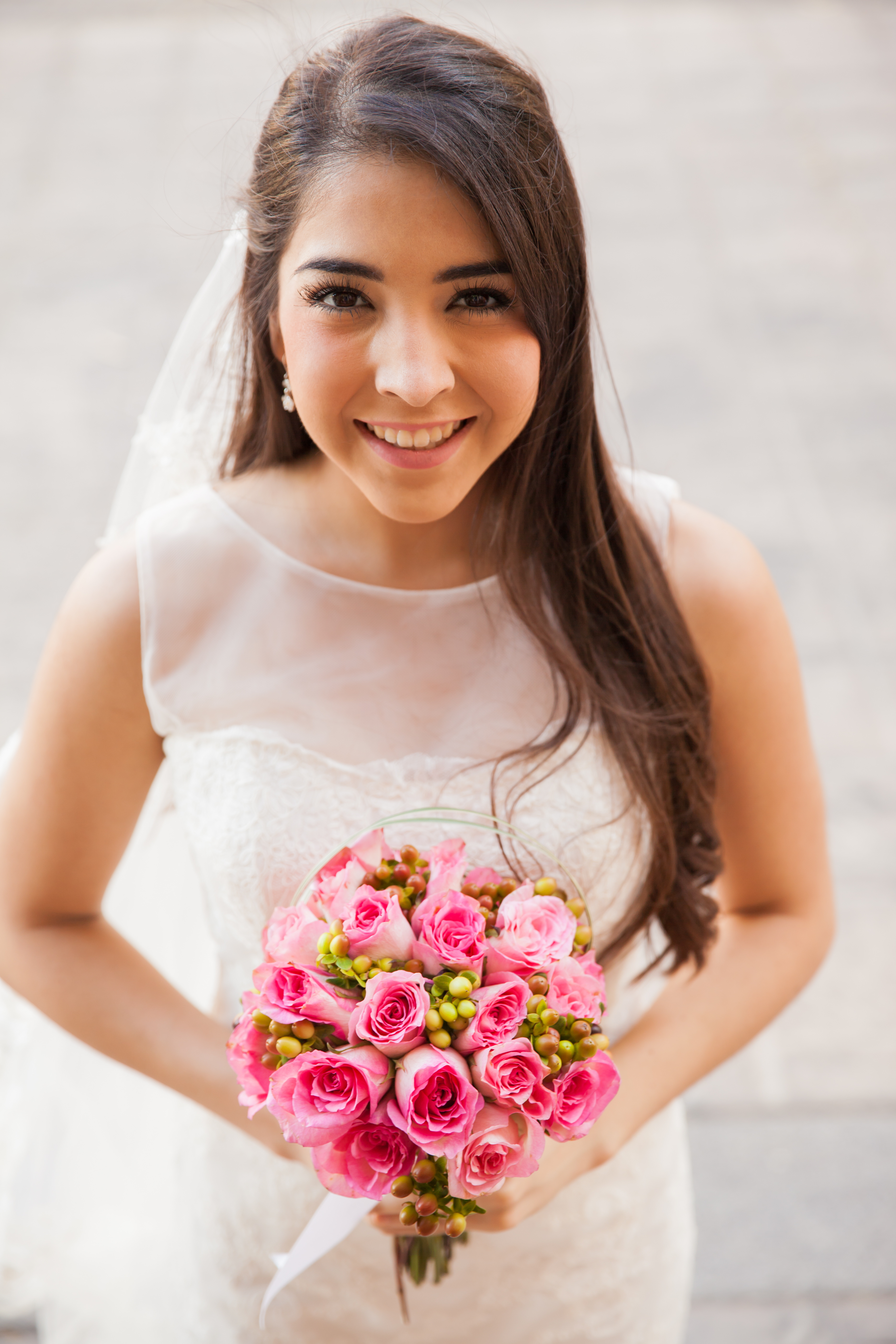 Happy Hispanic bride outdoors