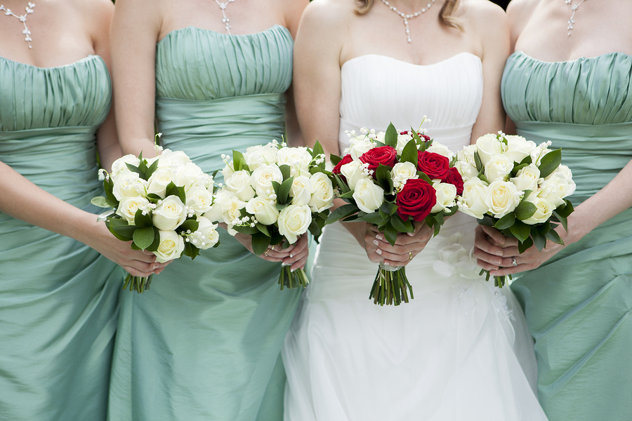 Close Up Of Bride And Bridesmaids Holding Flowers