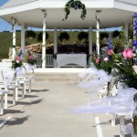 Flower arrangements on the pews at a wedding